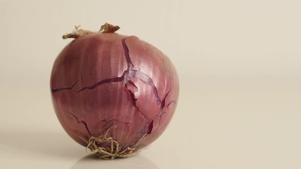 Onion with red skin and white flesh close-up 4K 2160p 30fps UltraHD tilting footage - Organic vegeta