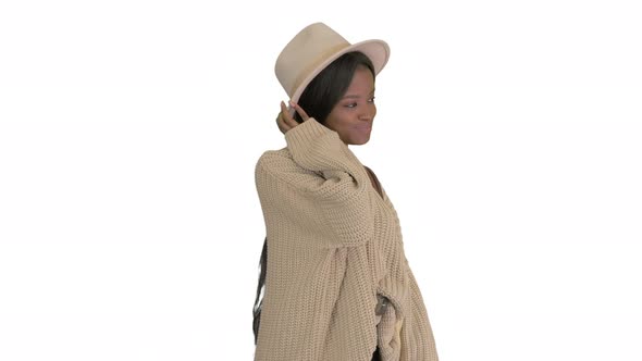 Fashionable African American Woman Posing in Knitwear and White Hat on White Background
