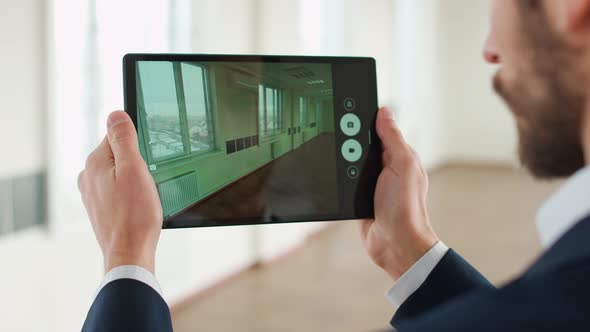 An Architect Scans the Office Space with the Help of Additional Reality Using the Digital Tablet