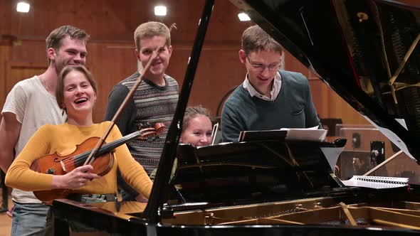 young people discussing a music training program and rehearsing a performance