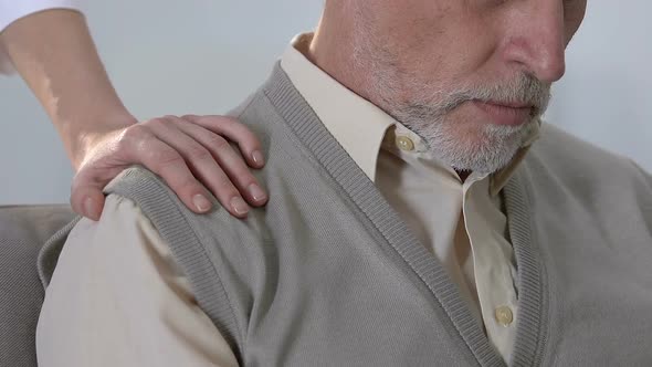 Daughter Putting Hand on Disappointed Old Man Shoulder, Supporting Father