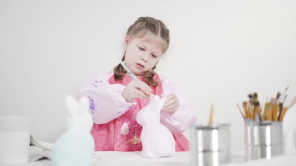 Little Girl Painting Paper Mache Figurine at Homeschooling Art Class