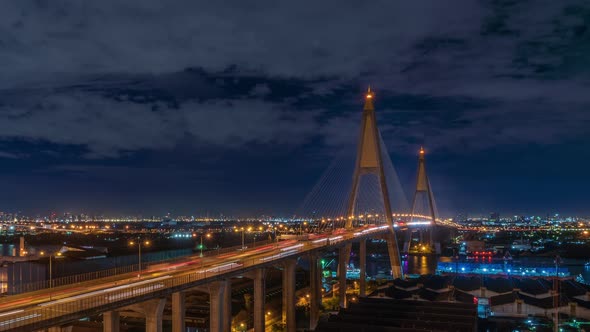 Large suspension bridge over Chao Phraya river with traffic, during night - Time Lapse