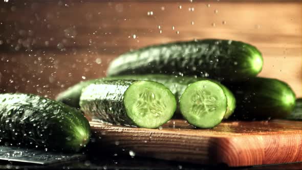 Drops of Water with Splashes Fall on Pieces of Fresh Cucumber