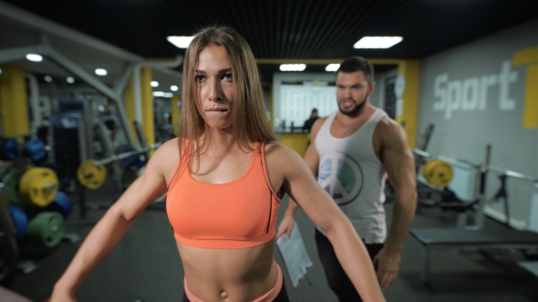 Of Young Girl With Dumbbells And Her Instructor