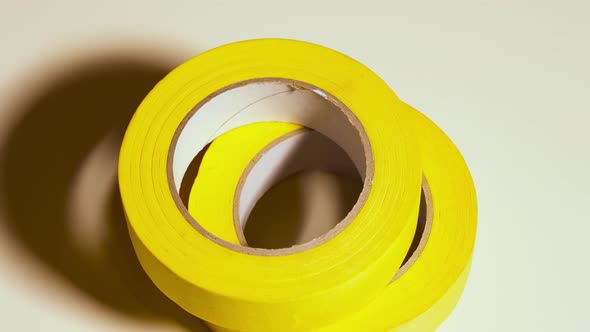 Yellow Sticky Tape Rotates on Gray Background