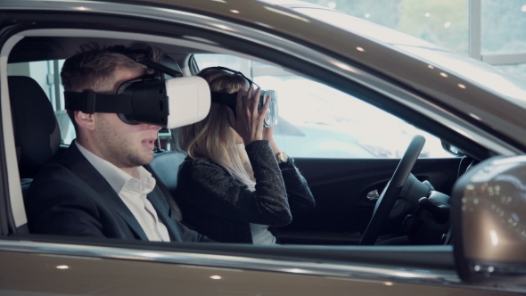 Young Woman Going For a Test Drive In a New Car Using VR