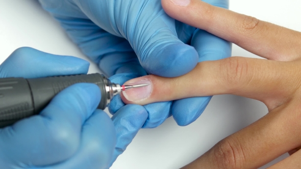 Master Of Manicure Treats The Cuticles With a Special Device.