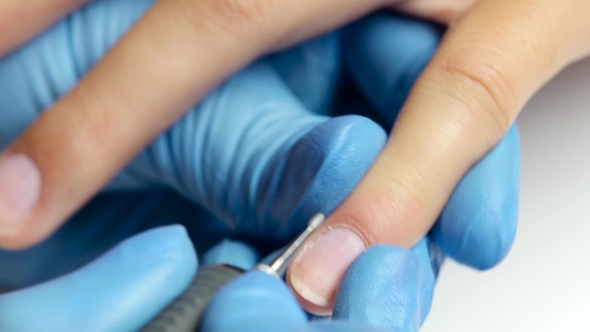 Professional Manicure Works With a Special Apparatus.