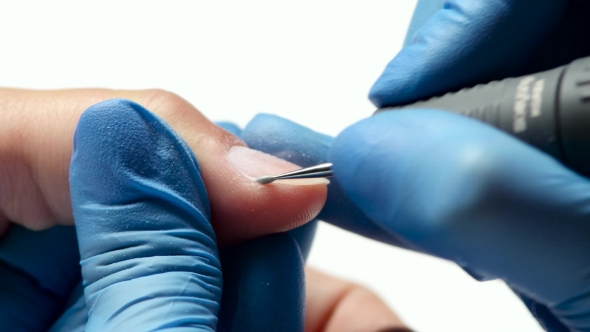 Manicurist Carries Out The Cleaning Procedure Of Finger From Skin.