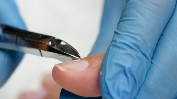 Master Of Manicure Removes Remnants Of Cuticle By Clippers.