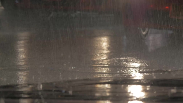 Cars Driving Under the Rain at Night alt