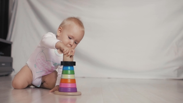 Baby Girl Playing With Educational Toy In Nursery. Logic Child Game alt