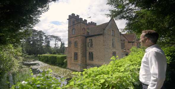 Man strolls up and views a historical castle