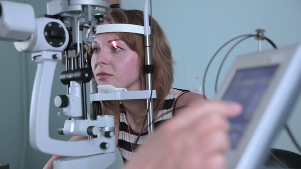 Modern Medical Procedure. Ophthalmologist Points At Touchscreen During Eye Examining.