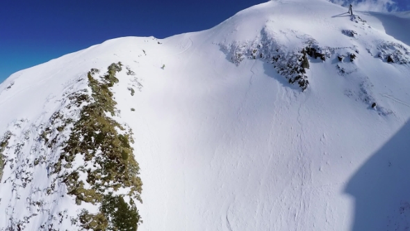 Quadrocopter Shoot Snowboarder Freestyle From Peak Of Snowy Mountain. Extreme