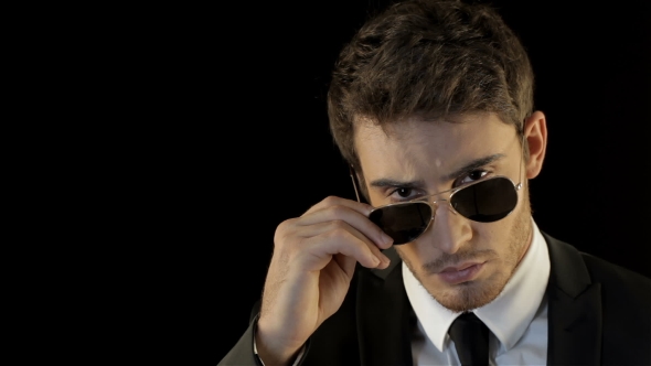 Man Looks Over His Sunglasses Like Special Agent