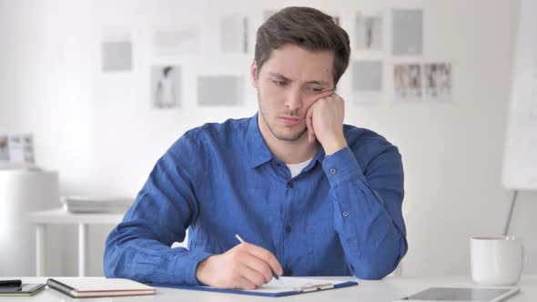 Pensive Casual Adult Man Writing an Article