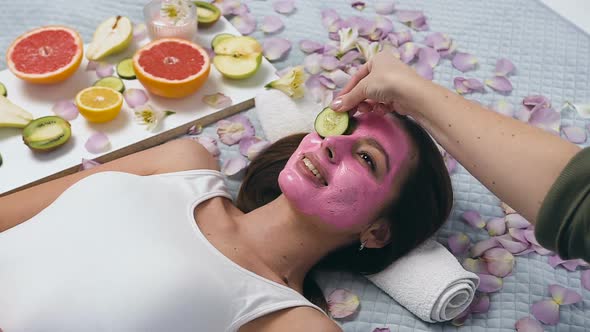 Young Woman With Pink Mask Relaxing in Wellness Center 