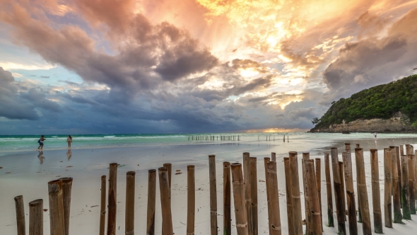 Sunset On a Background Of Fence Made Of Bamboo From The Waves On The Beach Of Boracay Island