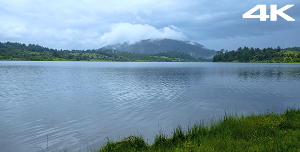 Lake with cloudy hill