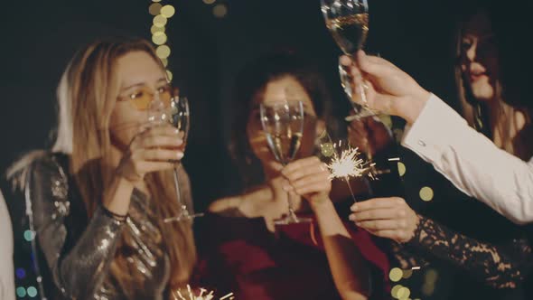 Closeup of Happy Faces of Young Guys Having Rest Together Clinking Glasses of Champagne