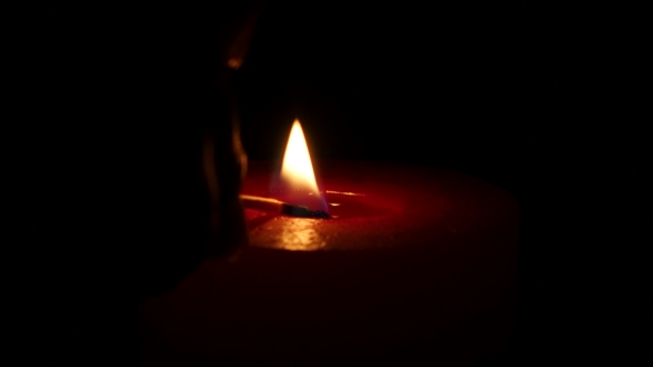 Burning Red Candle, Isolated On The Black Background.