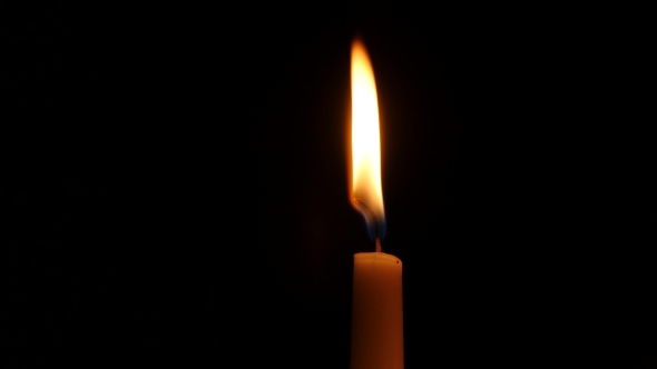 Burning Candle, Isolated On The Black Background.