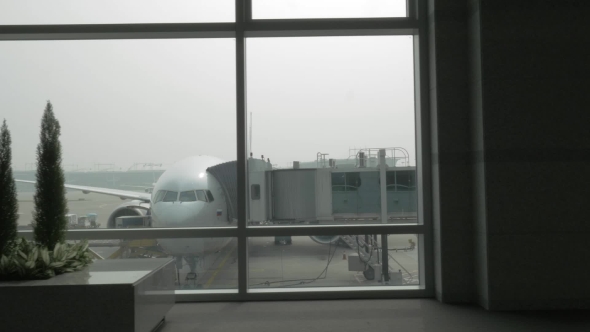 Unloading The Plane With Attached Air Bridge, View From The Window alt