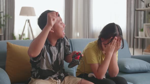 Children With Joystick Game Play Video Game On Tv, Boy Celebrating Victory And Girl Disappointed