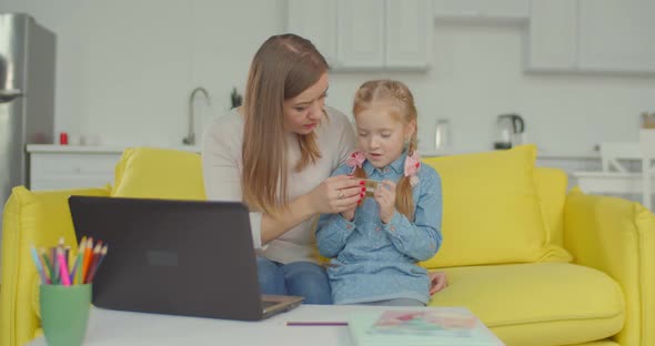 Woman Giving Online Shopping Education To Daughter