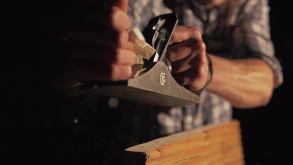 Wood shavings ejecting from carpenters hand planer, Medium shot