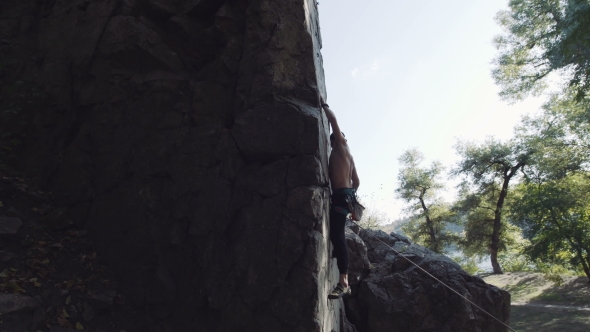 Professional Climber On Cliff Giving Instructions To Somebody