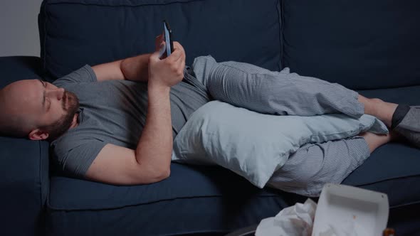 Sad Unhappy Depressed Shocked Depresive Man Browsing on Smartphone