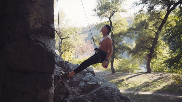 Climber Jumping From Cliff While Hanging On Rope