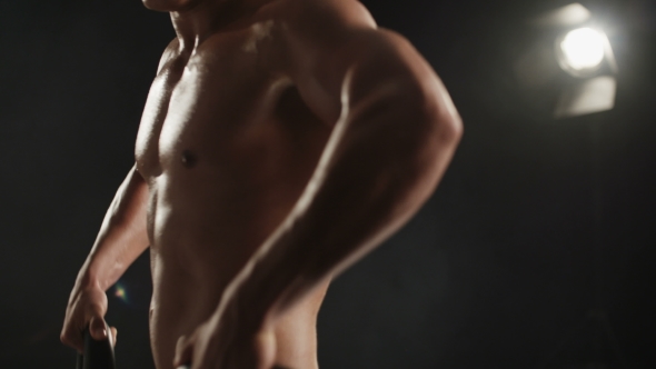 Healthy Young Man During Mass-building Shoulder Workout With His Head Not Visible.