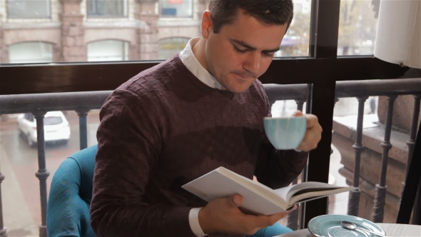 Man Reads Book At The Cafe