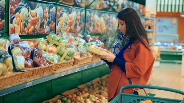 Happy Woman Grocery Shopping At The Supermarket