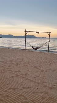 Women in a Hammock on the Beach in Pattaya During Sunset in Thailand Ban Amphur Beach