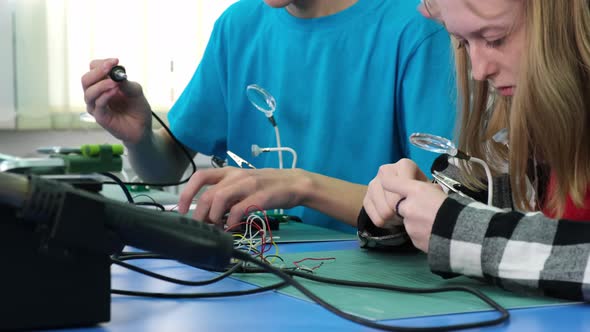 Teenagers Learn How to Work with an Electric Soldering Iron