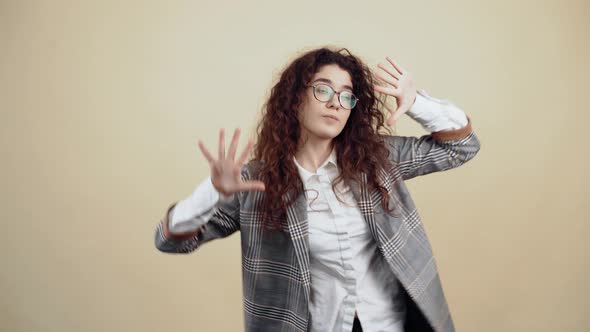 The Cheerful Young Woman Dances with Open Palms Waving Her Hands Left and Right Humming the Music