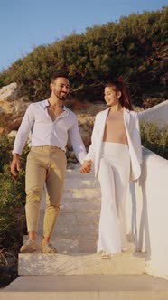 Smiling Ethnic Couple Walking and Kissing on Stairs