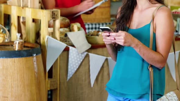 Woman text messaging on mobile phone