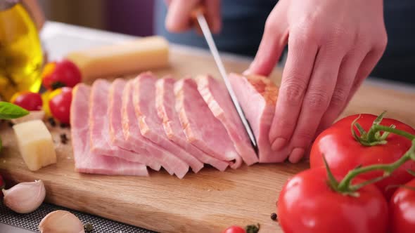 Making Pasta Carbonara Slicing Traditional Pancetta Bacon Into Pieces on a Wooden Cutting Board with