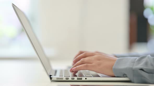 Close Up of African Woman Typing on Laptop