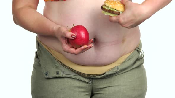 Fat Woman Holding Healthy and Unhealthy Food
