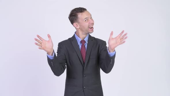 Studio Shot of Happy Businessman with Surprise Gesture