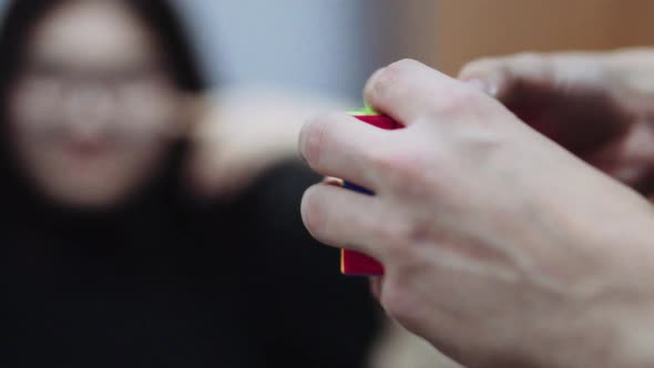 Man's Hands Collect a Puzzle Rubik's Cube