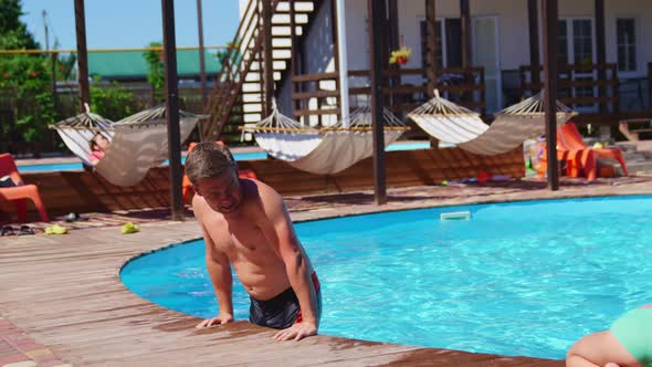 a Man Descending Into the Water of a Cold Pool