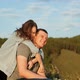 A Young Woman Hugs Her Boyfriend and Laughs. Happy Couple in the Park - VideoHive Item for Sale